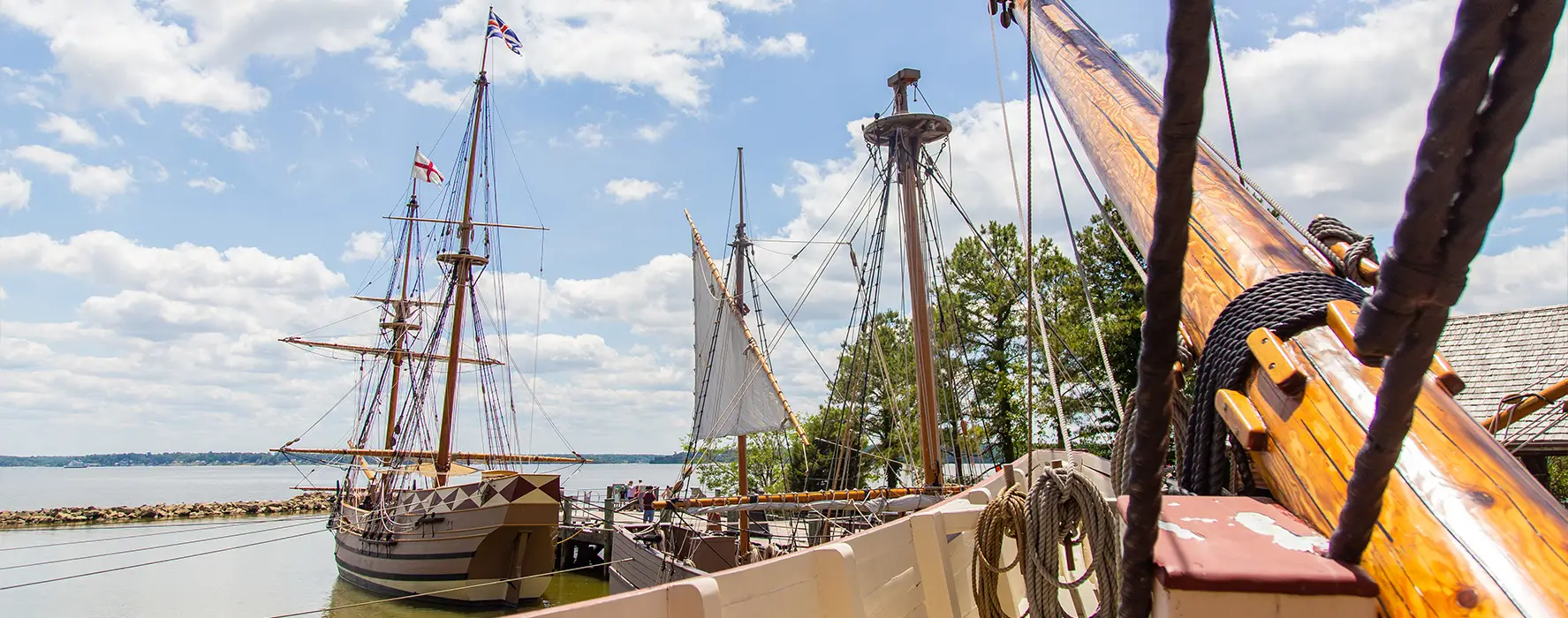 A photo of boats with sails in the water.