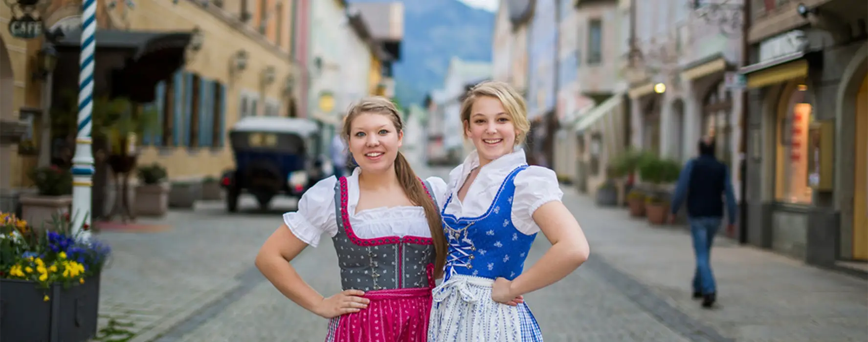 Two women posing for a photo in the street.